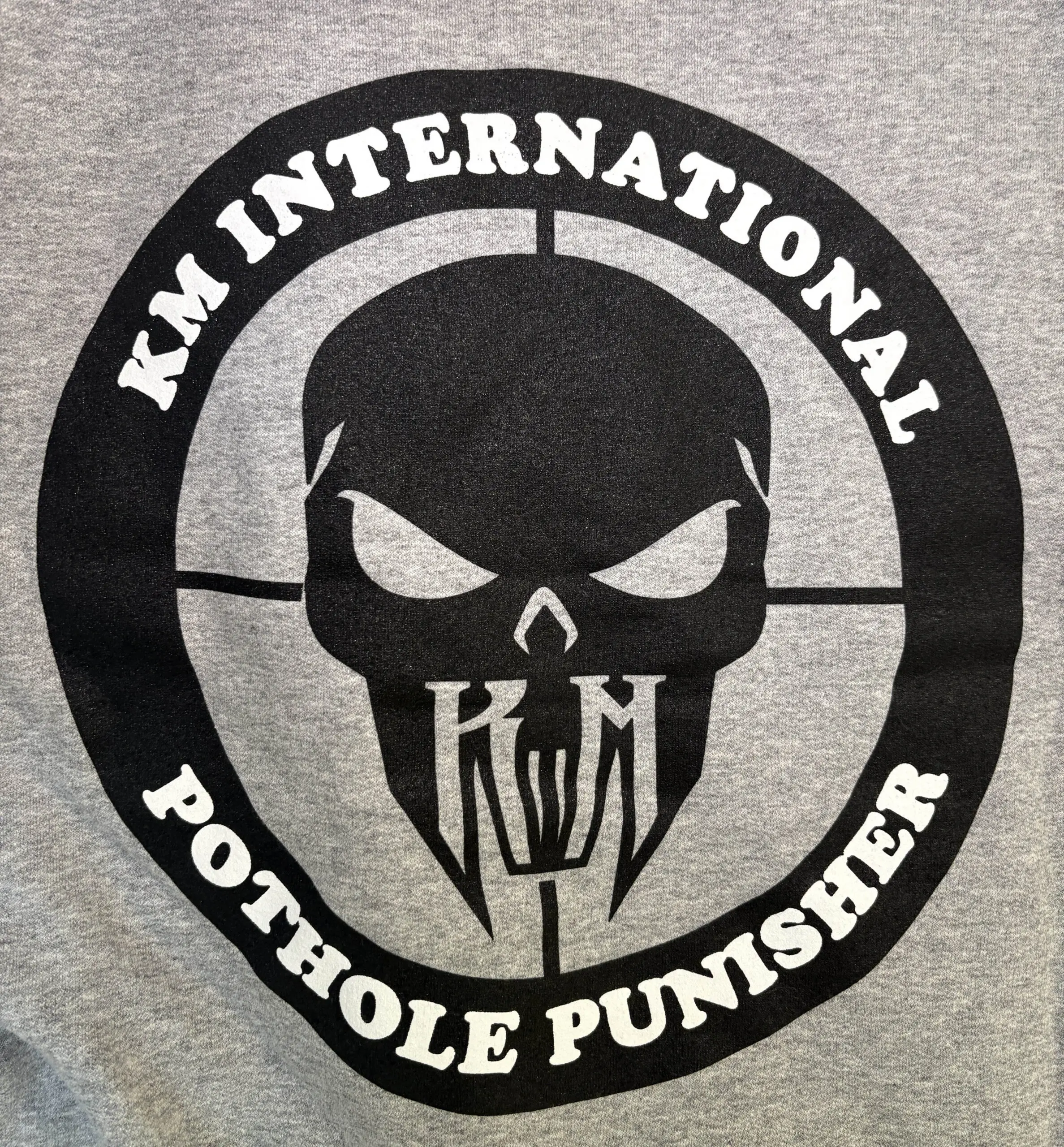 KM Pothole Punisher logo on the back of the hoodie